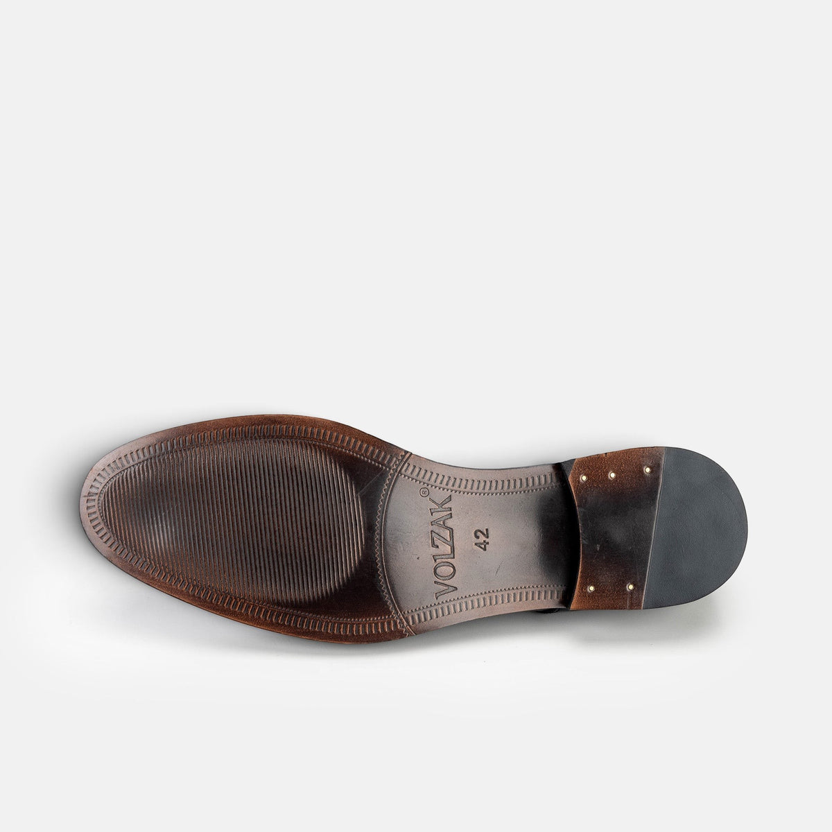 Bottom view of a VOLZAK black leather dress shoe sole with textured grip and stacked heel